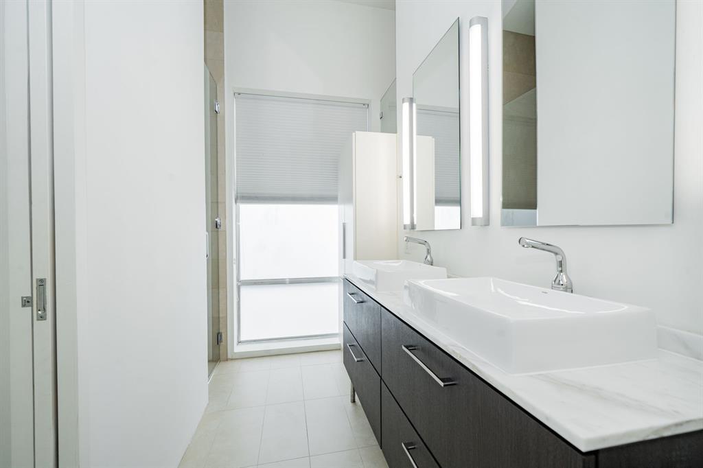 2325 Rusk Place Dallas, TX 75204 - Photo 18 of 27 a bathroom with a sink and a mirror