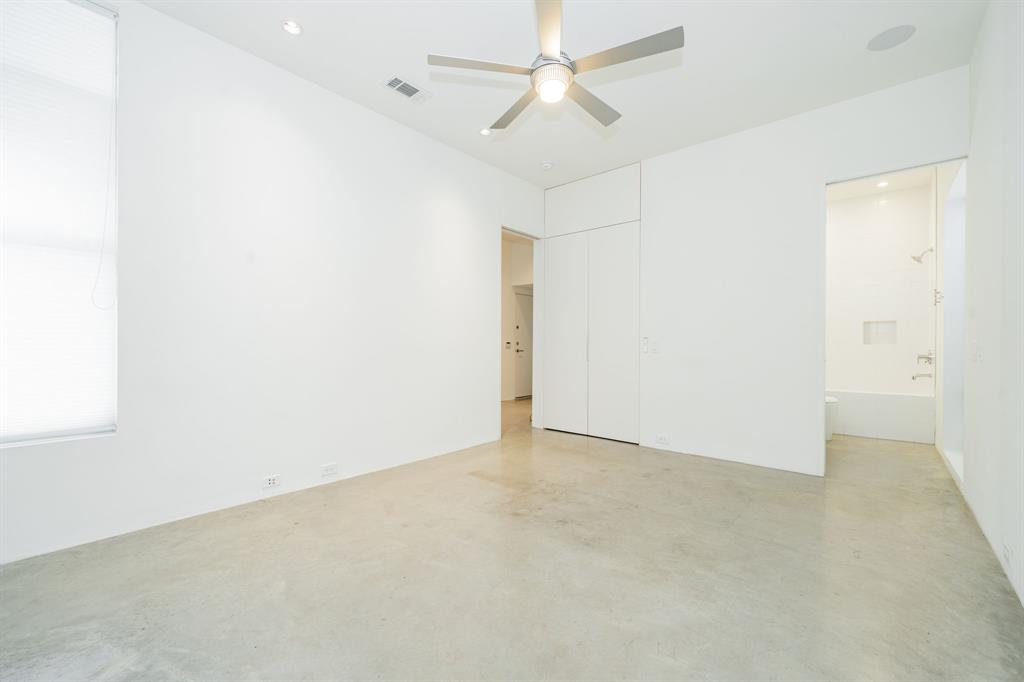 2325 Rusk Place Dallas, TX 75204 - Photo 23 of 27 an empty room with a ceiling fan and a window