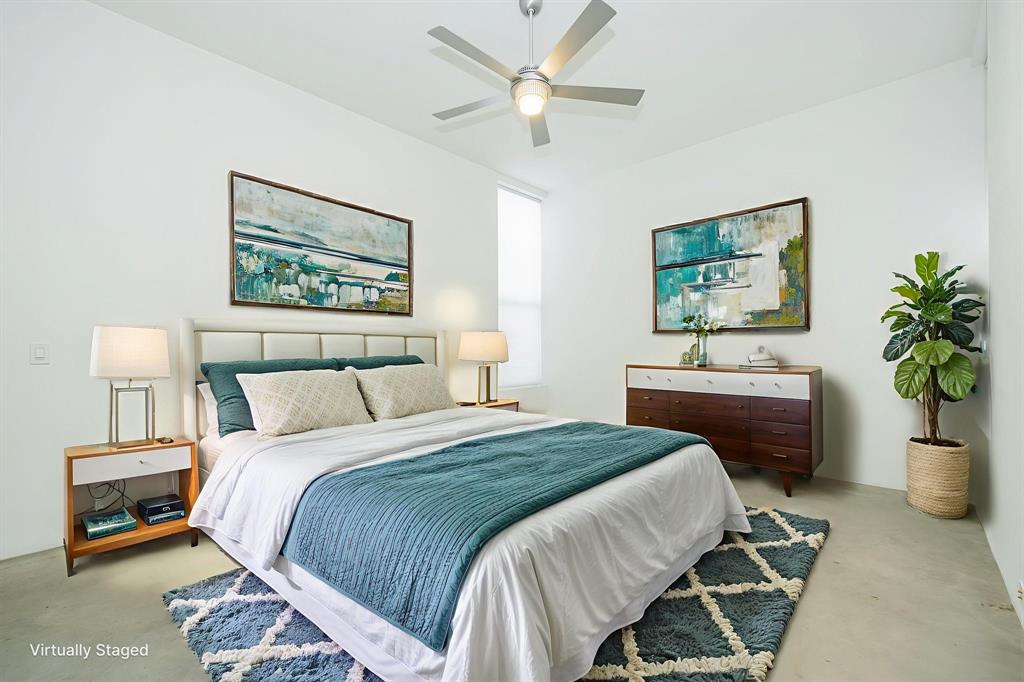 2325 Rusk Place Dallas, TX 75204 - Photo 24 of 27 a bedroom with a bed and a chandelier