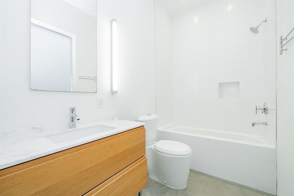 2325 Rusk Place Dallas, TX 75204 - Photo 25 of 27 a bathroom with a sink a toilet and shower