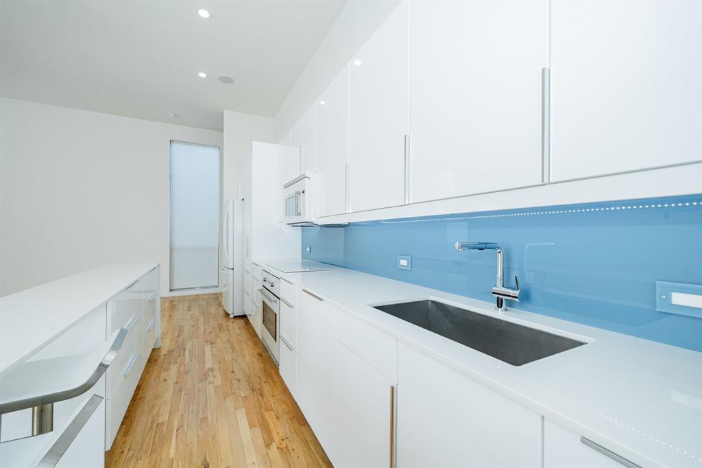2325 Rusk Place Dallas, TX 75204 - Photo 6 of 27 a kitchen with a sink and cabinets
