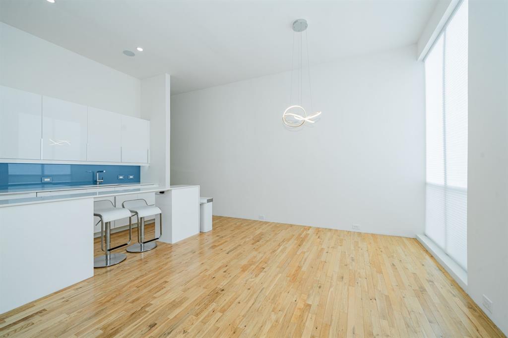 2325 Rusk Place Dallas, TX 75204 - Photo 10 of 27 a room with wooden floor and white walls