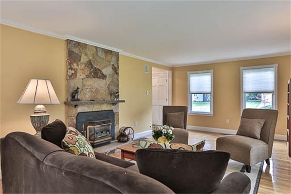 2648 Massachusetts Avenue Lexington, MA 02421 - Photo 11 of 19 a living room with furniture and a fireplace