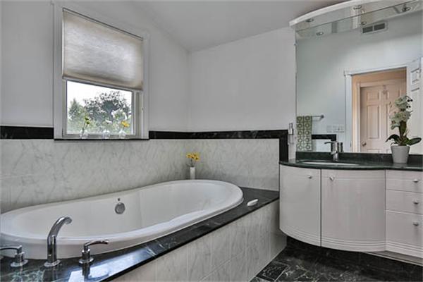 2648 Massachusetts Avenue Lexington, MA 02421 - Photo 14 of 19 a bathroom with a tub and a sink