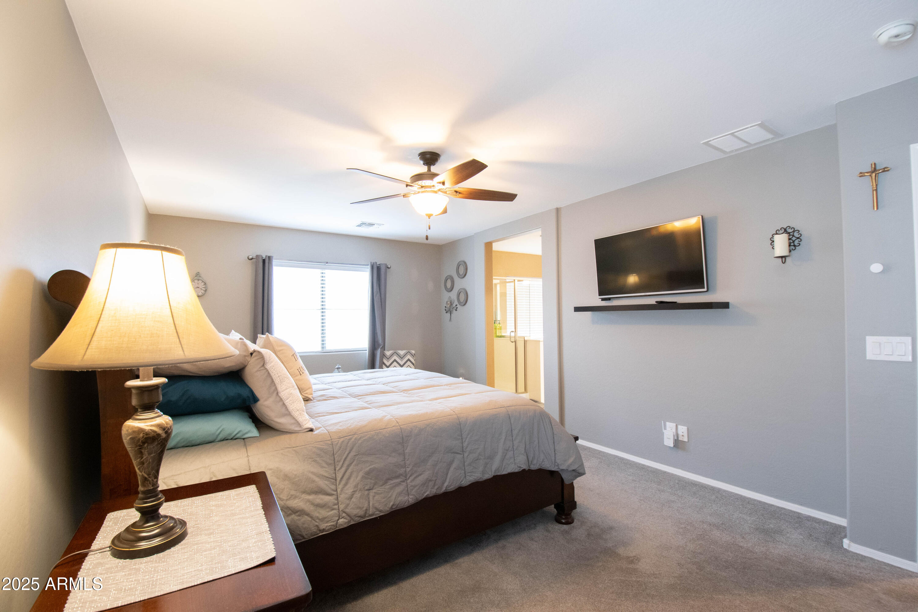 3924 South Napa Lane Gilbert, AZ 85297 - Photo 14 of 42 a bedroom with a bed and a flat screen tv