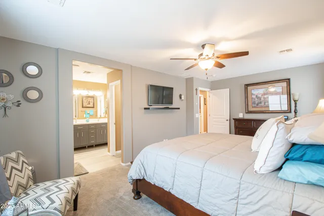 a bedroom with a bed and a chandelier