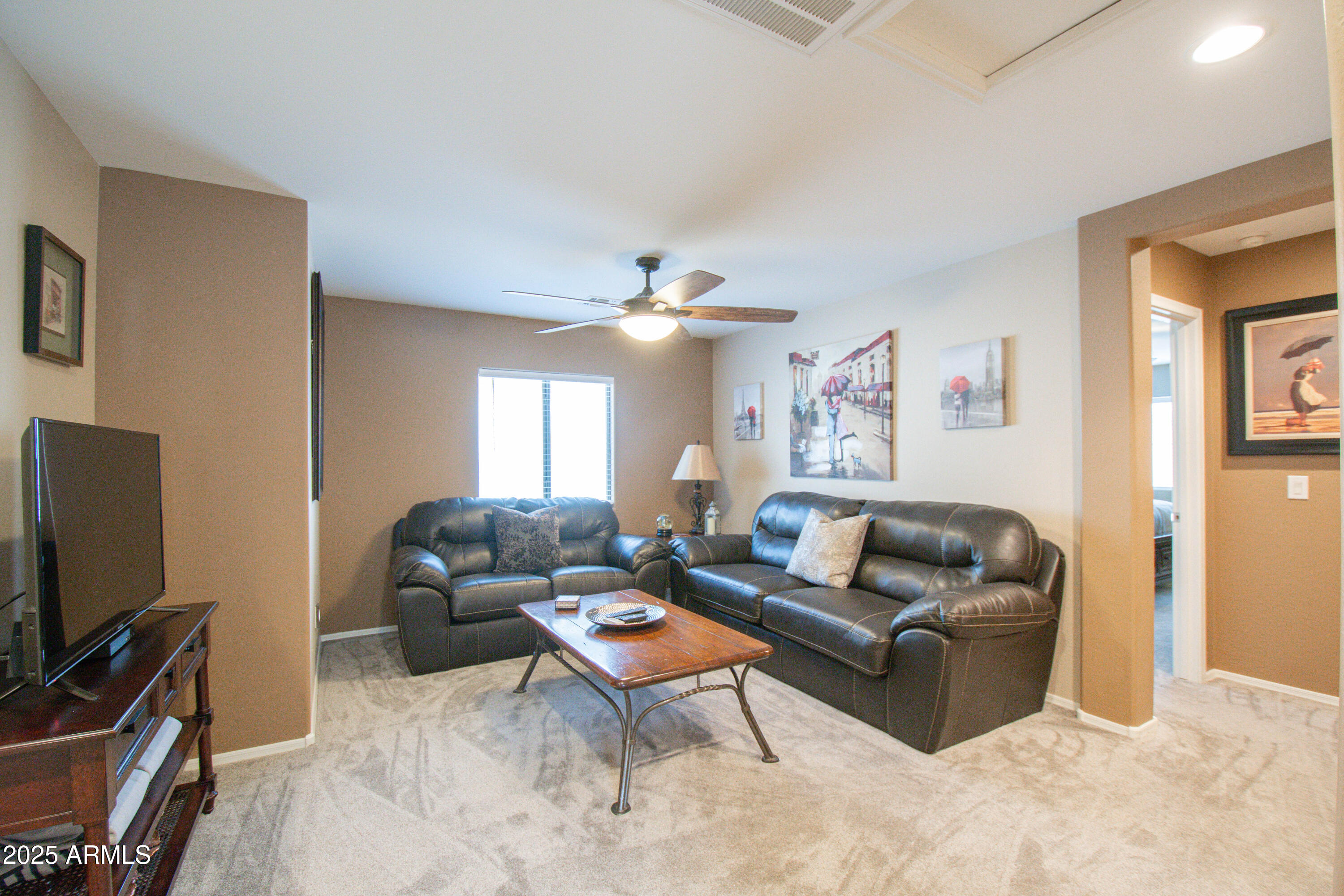 3924 South Napa Lane Gilbert, AZ 85297 - Photo 21 of 42 a living room with furniture a ceiling fan and a window