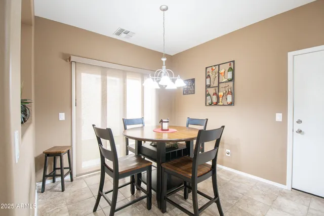 a dining room with furniture a chandelier and window
