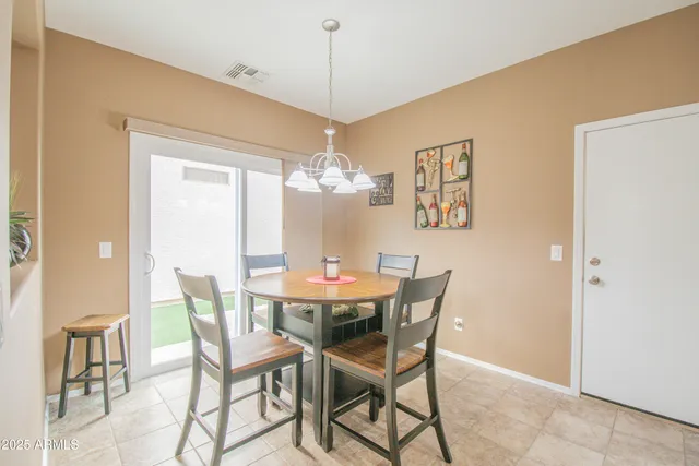 a view of a dining room with furniture and chandelier