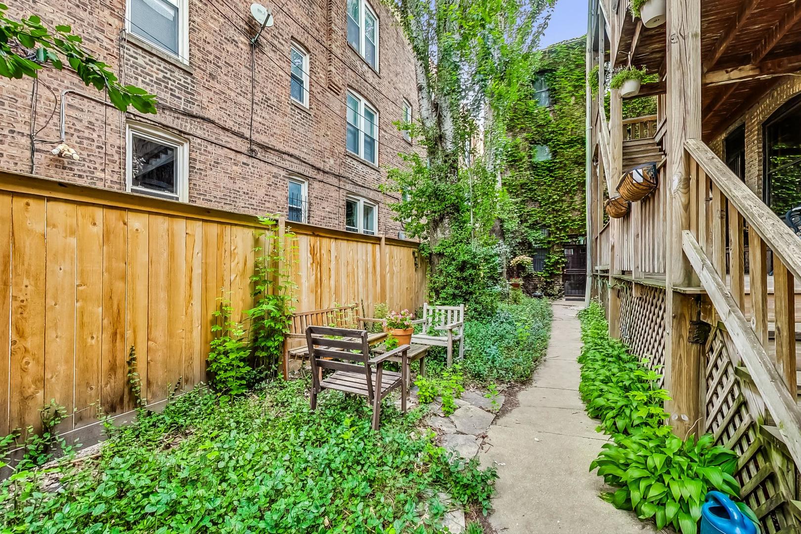 2004 West Walton Street, Unit 2B Chicago, IL 60622 - Photo 15 of 17 a backyard of a residential building with barbeque oven and outdoor seating