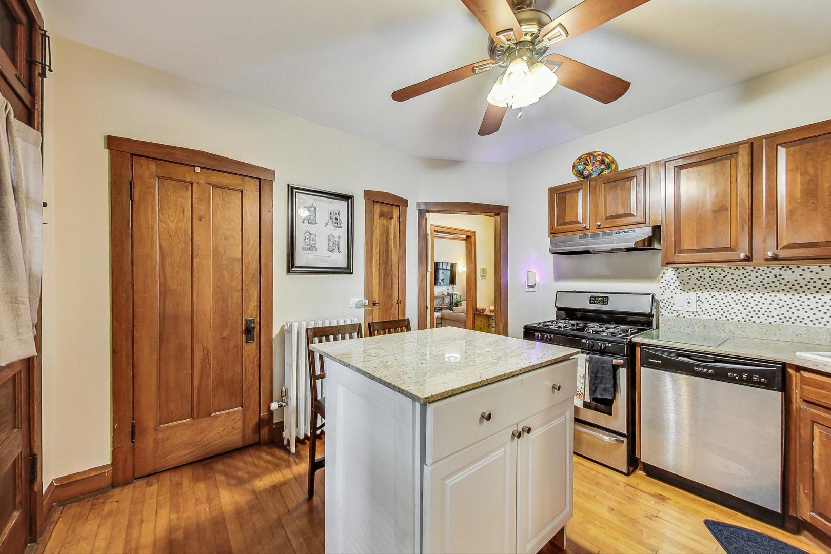 2004 West Walton Street, Unit 2B Chicago, IL 60622 - Photo 6 of 17 a kitchen with granite countertop cabinets stainless steel appliances and a counter space