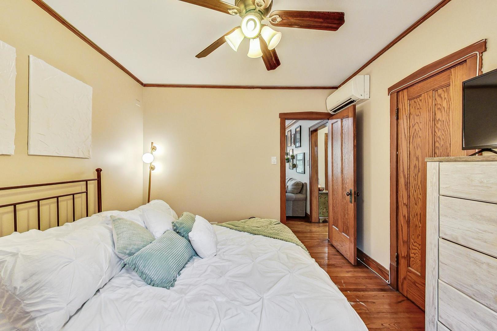 2004 West Walton Street, Unit 2B Chicago, IL 60622 - Photo 9 of 17 a bedroom with a large bed and a chandelier