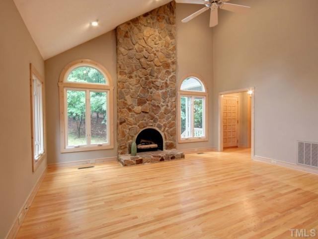 1304 Velvet Court Raleigh, NC 27614 - Photo 2 of 12 Dramatic family room features cathedral ceiling, stone gas log fireplace, skylights, hardwood floors and ceiling fan.
