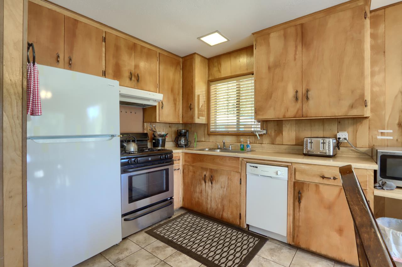 2628 West Bruce Road Wawona, CA 95389 - Photo 14 of 33 a kitchen with stainless steel appliances granite countertop a refrigerator sink and cabinets