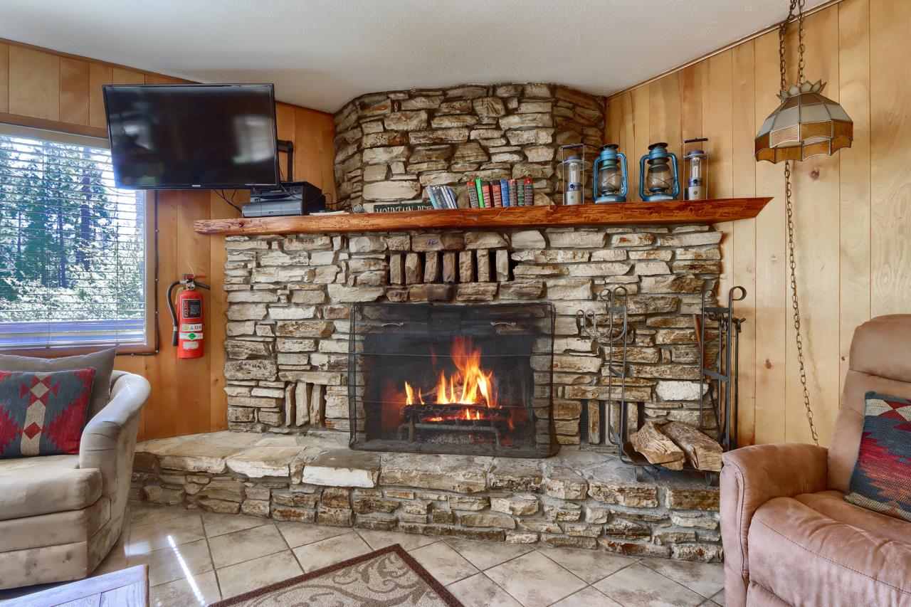 2628 West Bruce Road Wawona, CA 95389 - Photo 9 of 33 a living room with furniture a fireplace and a large window