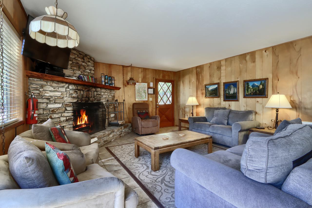 2628 West Bruce Road Wawona, CA 95389 - Photo 10 of 33 a living room with furniture a fireplace and a flat screen tv