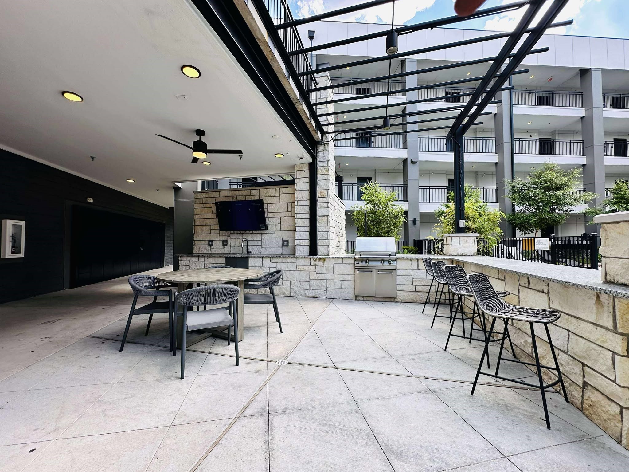 2603 North Fry Road, Unit A1 Katy, TX 77449 - Photo 2 of 13 a outdoor space with lots of tables a chair and a fireplace