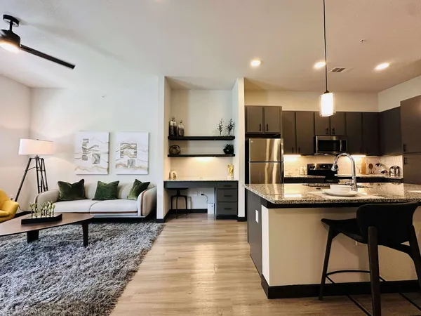 a kitchen with stainless steel appliances kitchen island granite countertop a sink counter space and cabinets