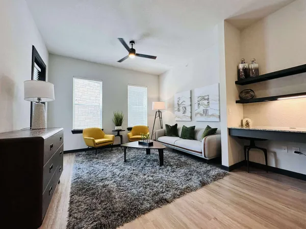 a living room with furniture and wooden floor