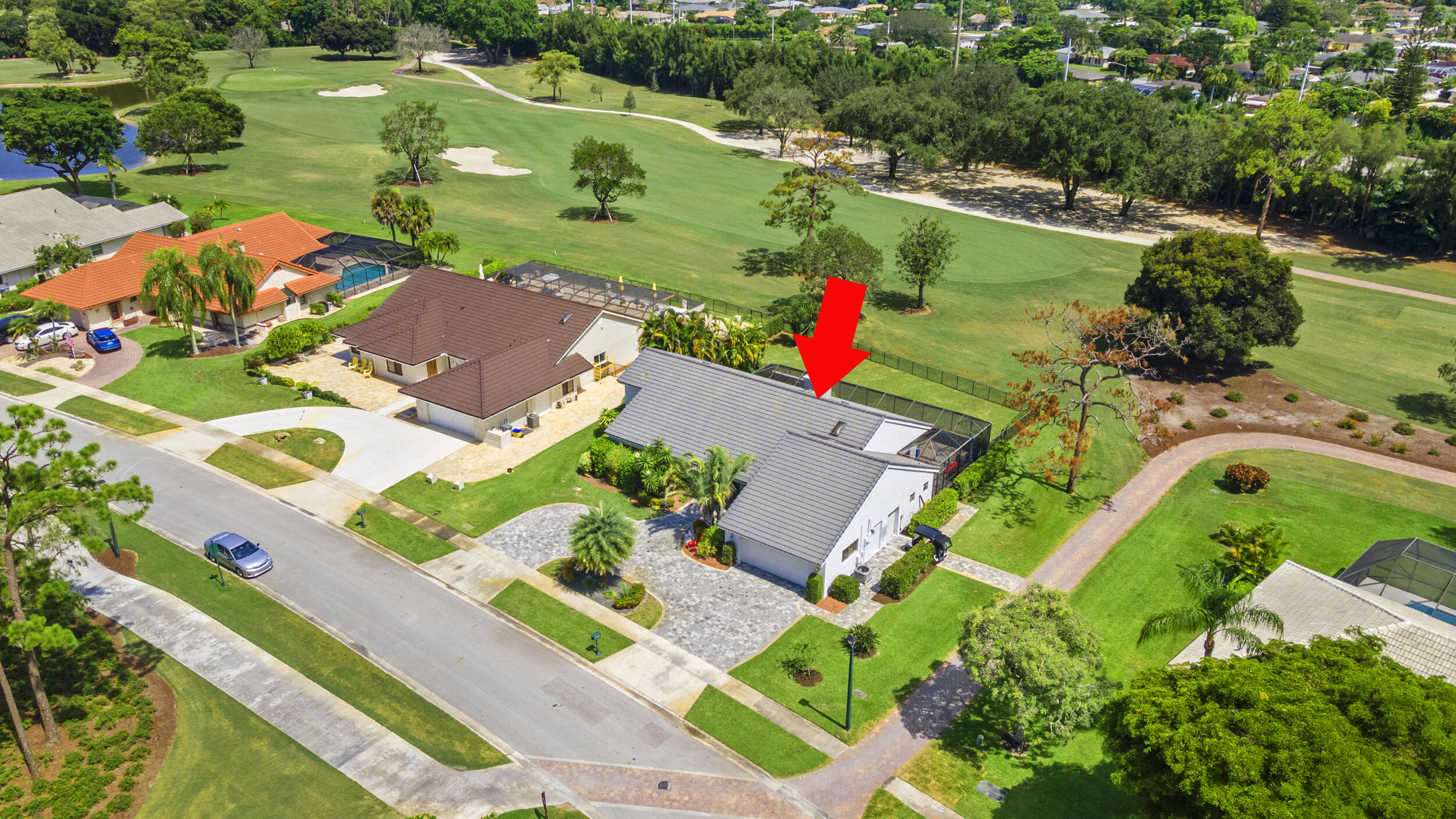 an aerial view of a house with a garden and lake view
