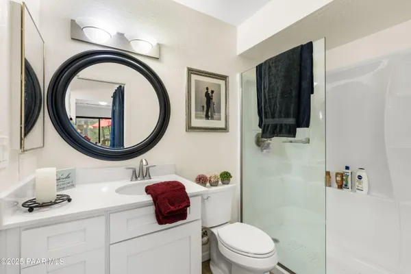 a bathroom with a toilet a sink and a mirror