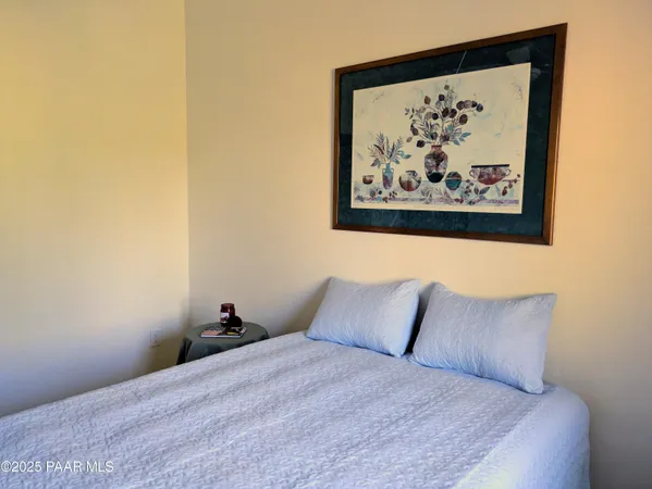a bedroom with a bed and wall painting