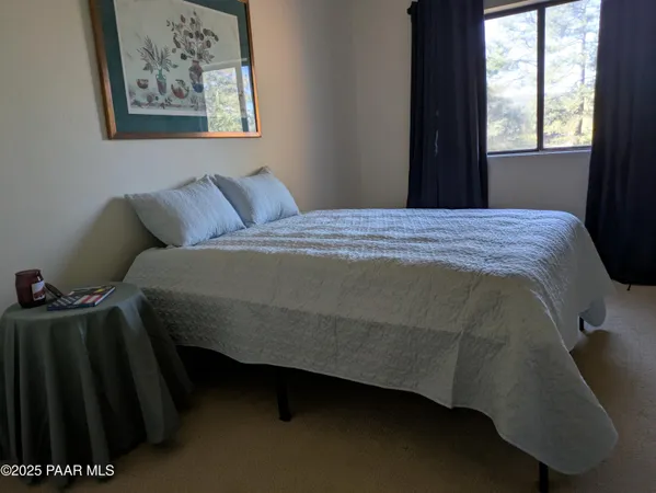 a bed sitting in a bedroom next to a window