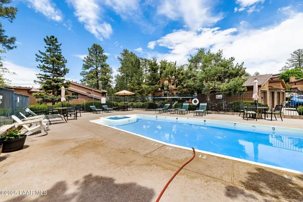 a view of a swimming pool with outdoor seating