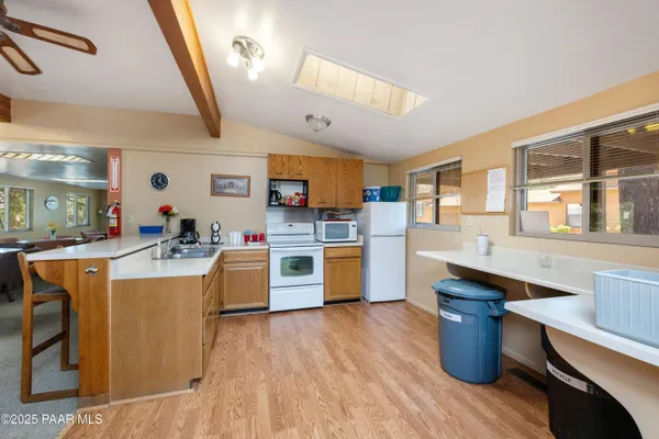a large kitchen with stainless steel appliances kitchen island granite countertop a stove and a sink