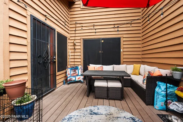 a view of a patio with table and chairs and wooden floor