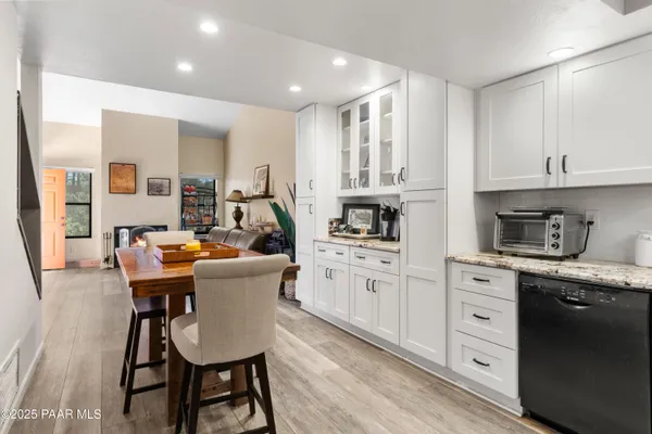 a kitchen with white cabinets and stainless steel appliances