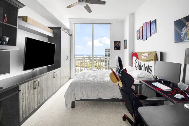 a bedroom with furniture and a flat screen tv