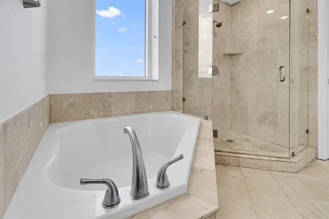 a bathroom with a tub and a shower