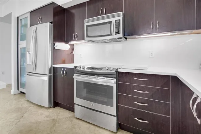 a kitchen with granite countertop cabinets and steel stainless steel appliances