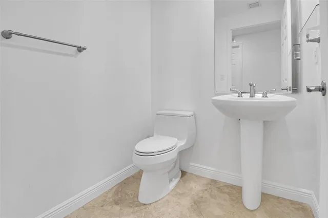 a bathroom with a sink toilet and a mirror