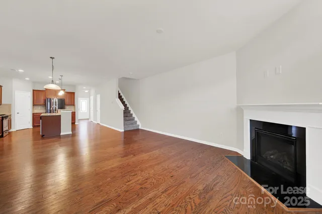 a view of a kitchen with a sink and a fireplace