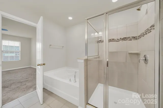 a bathroom with a bathtub and a shower