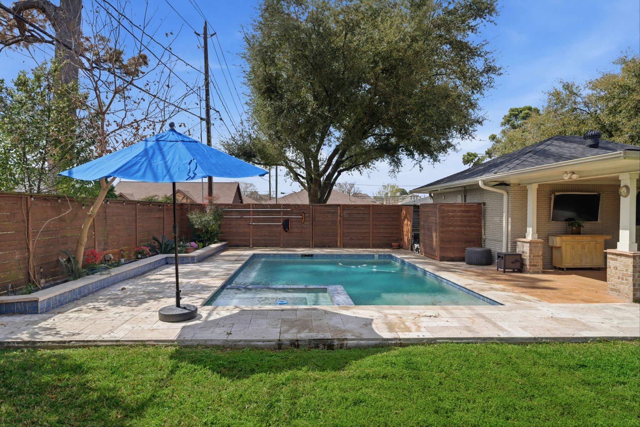 6427 Waltway Drive Houston, TX 77008 - Photo 16 of 37 This backyard features a private swimming pool with a spacious patio area, perfect for relaxation and entertaining. The wooden fence and mature trees provide privacy and a natural ambiance.