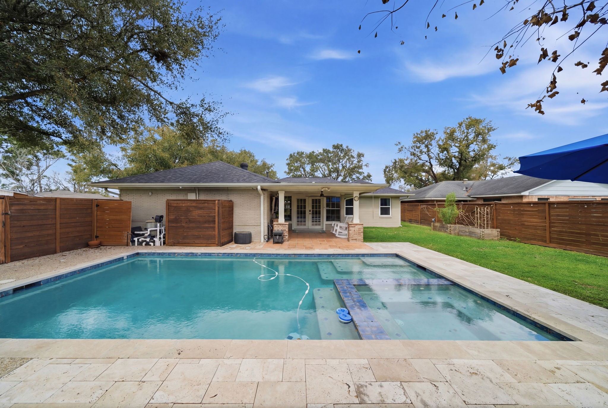 6427 Waltway Drive Houston, TX 77008 - Photo 17 of 37 View from the back yard to the house. Showcasing the pool, side yard and covered patio.