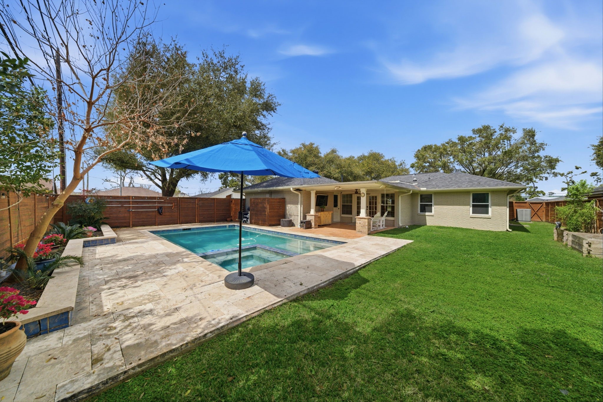 6427 Waltway Drive Houston, TX 77008 - Photo 18 of 37 This charming backyard features a cozy patio area with seating, a refreshing swimming pool, and a spacious lawn. Ideal for relaxation and outdoor entertaining.