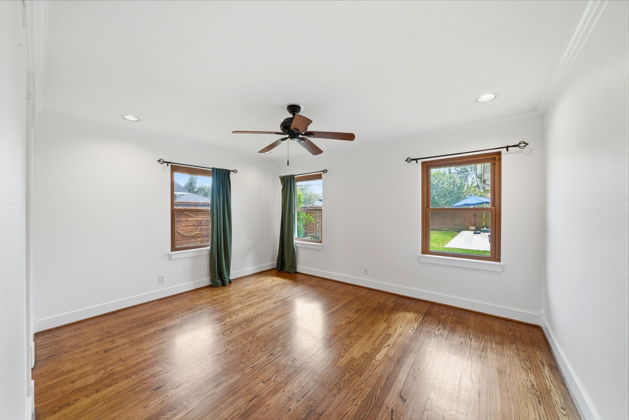 6427 Waltway Drive Houston, TX 77008 - Photo 23 of 37 Three windows offer views of the backyard, providing natural light and a welcoming atmosphere.