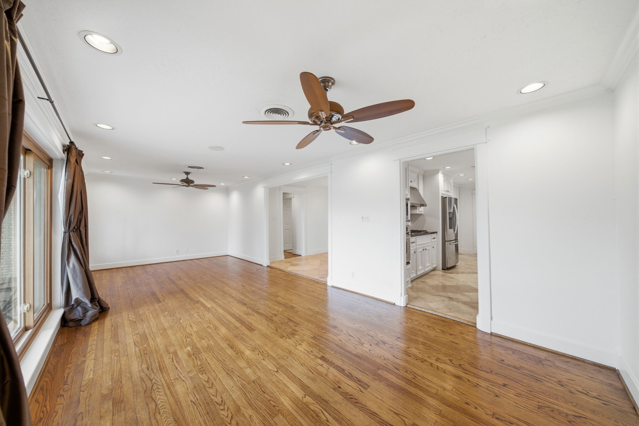6427 Waltway Drive Houston, TX 77008 - Photo 5 of 37 Living room is connected to a modern kitchen with stainless steel appliances, and dining room.