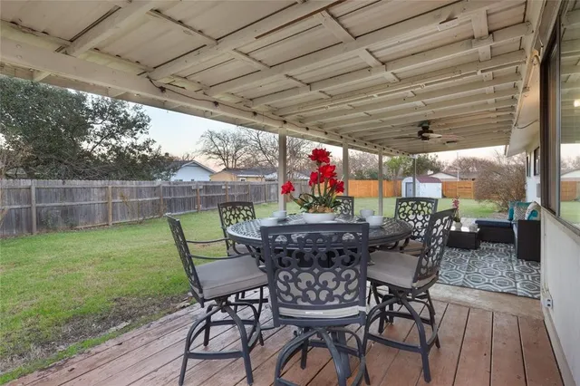 a view of a dinning table and chairs in the patio