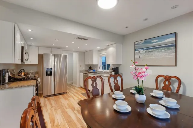 a living room with furniture and a dining table