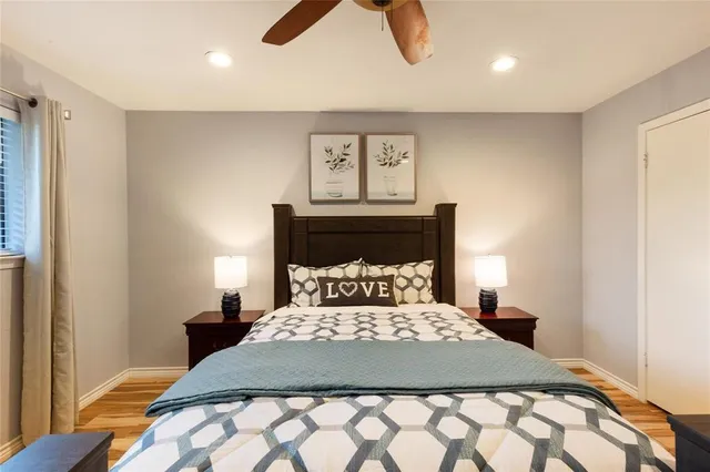 a bedroom with a bed and painting on the wall