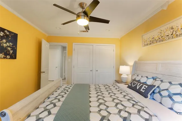 a bedroom with a bed and a lamp on the dresser