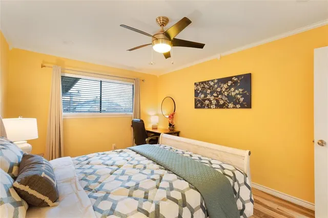 a bedroom with a bed and a painting on the wall