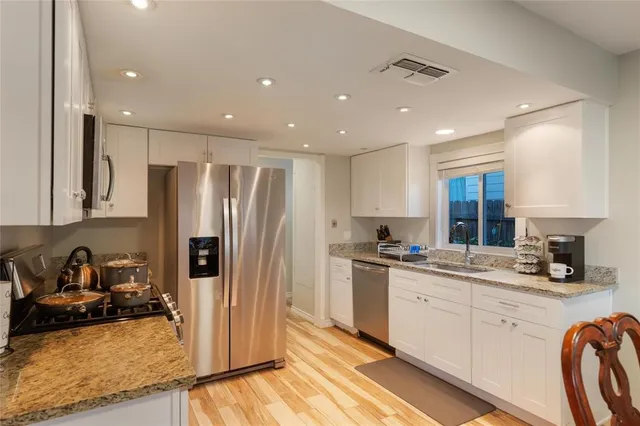 a kitchen with refrigerator and sink