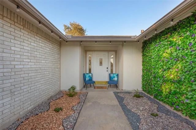 a balcony with furniture and potted plants