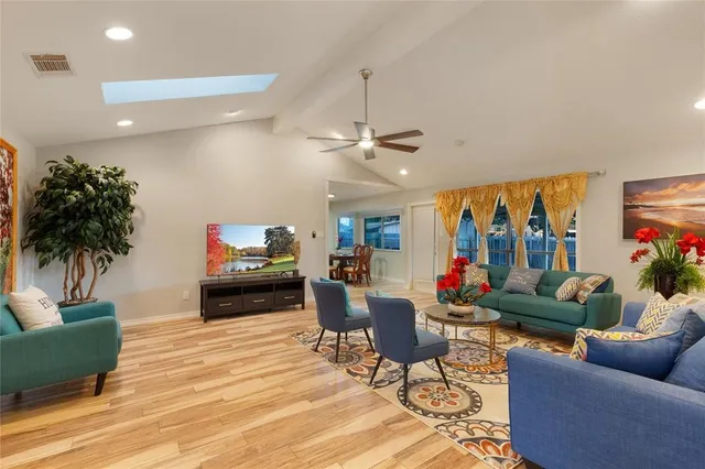 a living room with furniture and a potted plant